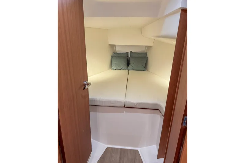 Slide: The Image of 2026 J Boats J/36 cabin interior with cozy bed and pillows. - 14