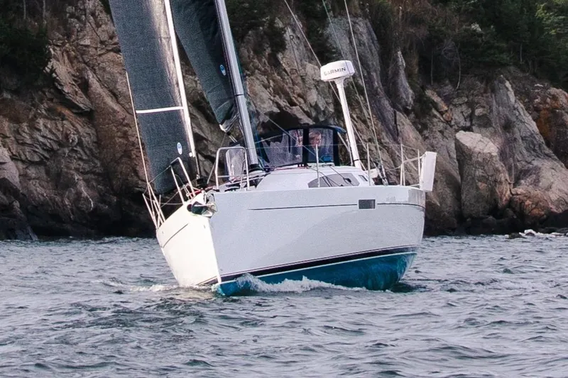 Slide: The Image of 2026 J Boats J/36 sailing near rocky coastline. - 4