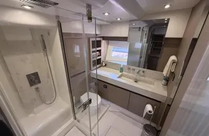 Slide: The Image of Luxurious bathroom in 2018 Prestige 680 yacht with modern fixtures and glass shower. - 12