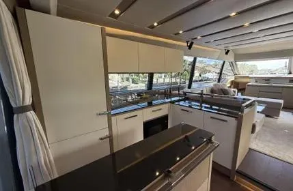 Slide: The Image of Luxurious interior of 2018 Prestige 680 yacht, featuring modern kitchen and spacious seating area. - 14