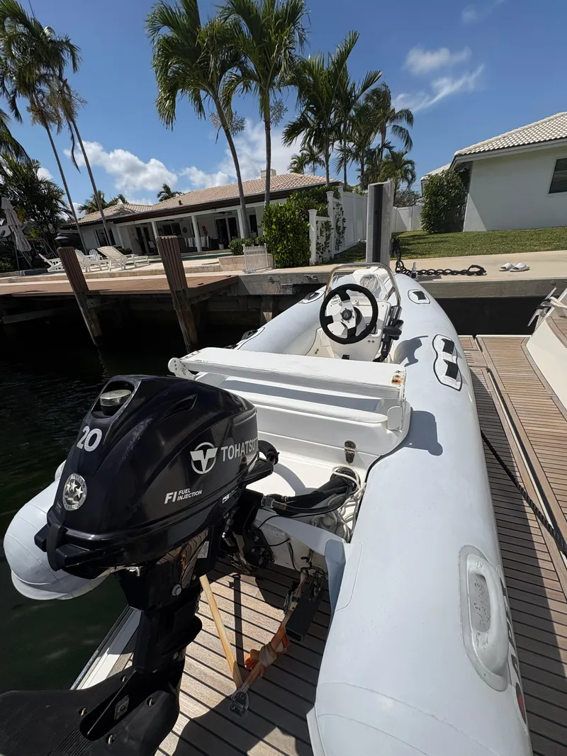 Slide: The Image of 2018 Prestige 680 inflatable boat docked, featuring a Tohatsu 20 HP outboard motor. - 29