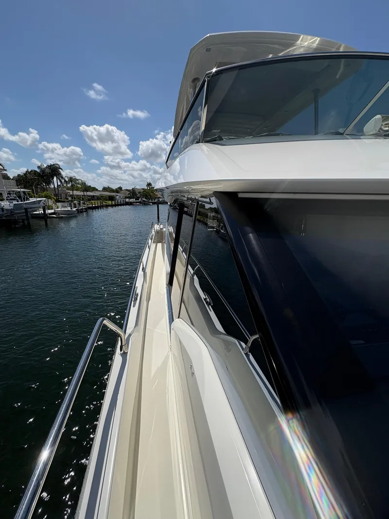 Slide: The Image of 2018 Prestige 680 yacht docked, showcasing sleek design and luxurious features under a clear sky. - 31