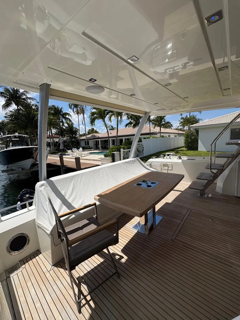 Slide: The Image of Luxury yacht deck with seating area, Prestige 680, 2018 model, docked near waterfront homes. - 38