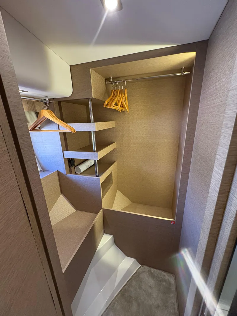 Slide: The Image of Walk-in closet on 2018 Prestige 680 yacht with shelves and hangers. - 43
