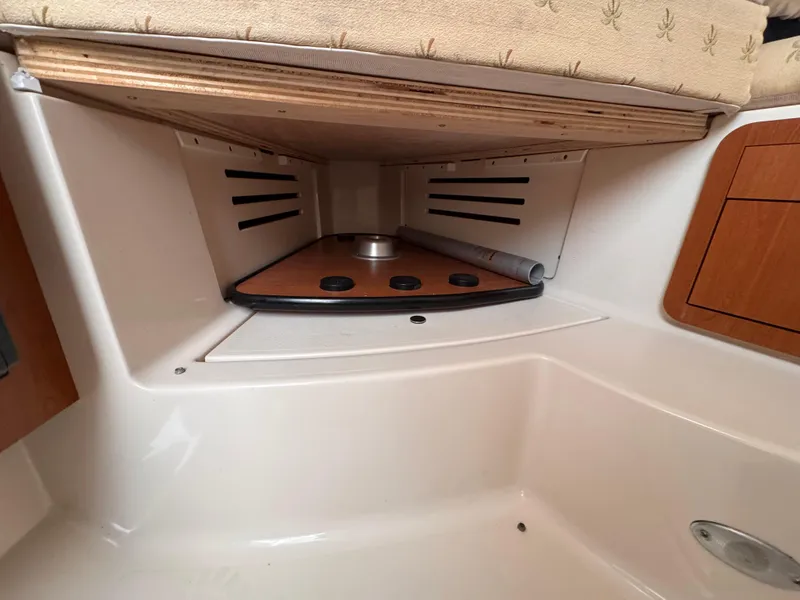 Slide: The Image of 2006 Wellcraft 290 Coastal cabin interior with wood accents and storage space. - 17