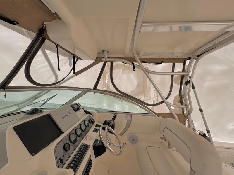 Slide: The Image of 2006 Wellcraft 290 Coastal boat interior with steering wheel and control panel. - 18