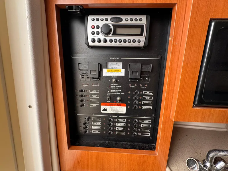 Slide: The Image of Electrical control panel in a 2006 Wellcraft 290 Coastal boat, featuring a mounted radio. - 2