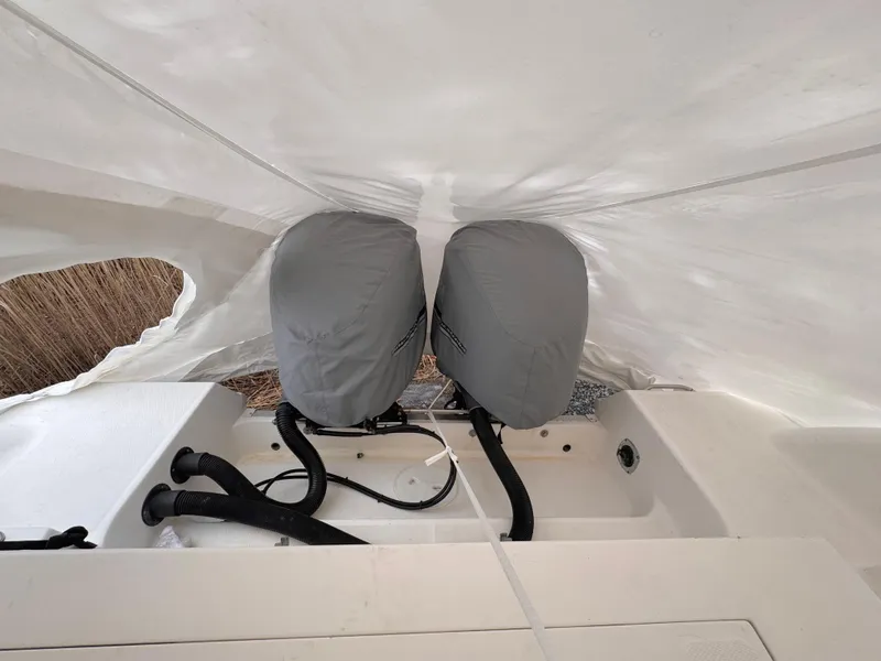 Slide: The Image of Covered engines on a 2006 Wellcraft 290 Coastal boat under a protective tarp. - 3