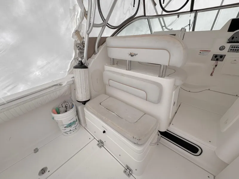 Slide: The Image of 2006 Wellcraft 290 Coastal boat interior with white seating and storage area. - 5