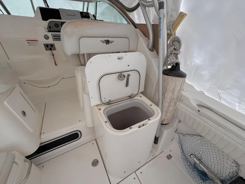 Slide: The Image of 2006 Wellcraft 290 Coastal boat interior with open storage compartment. - 6