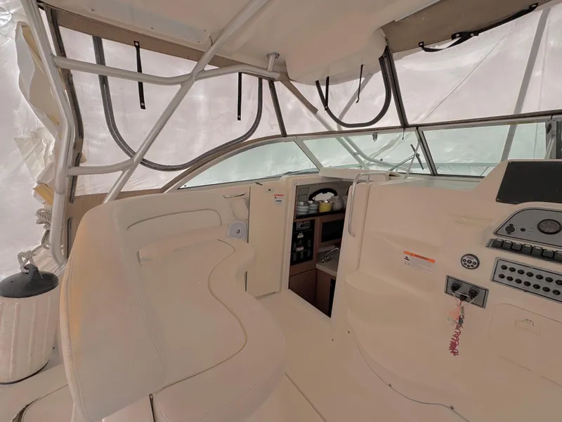 Slide: The Image of 2006 Wellcraft 290 Coastal boat interior with helm and seating area. - 7