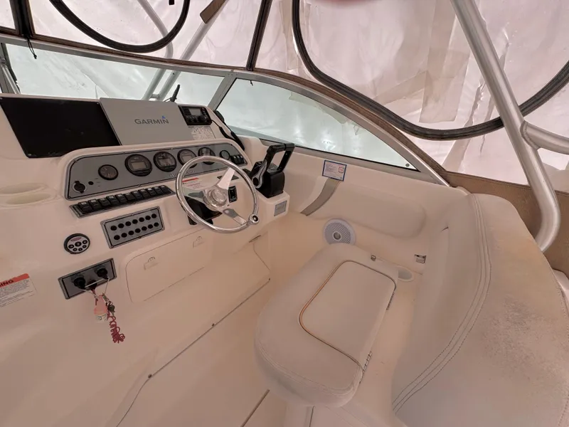 Slide: The Image of 2006 Wellcraft 290 Coastal boat helm with steering wheel and navigation controls. - 8