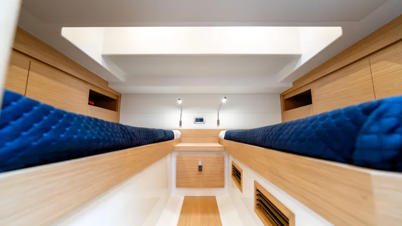 Slide: The Image of Interior of 2025 Pardo Yachts 38, featuring sleek wood finish and blue seating. - 34