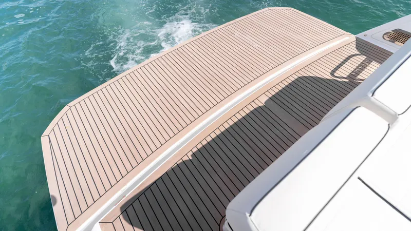 Slide: The Image of Teak deck of 2025 Pardo Yachts 38, overlooking clear blue water. - 11