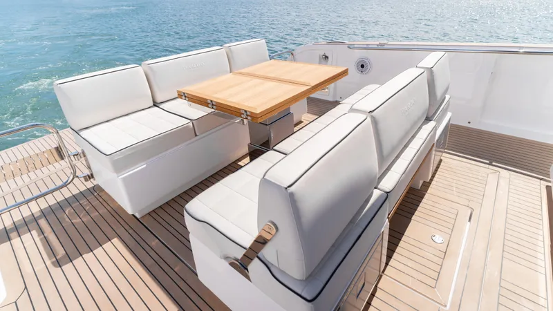 Slide: The Image of Luxurious seating area on 2025 Pardo Yachts 38, featuring elegant white cushions and wooden table. - 14