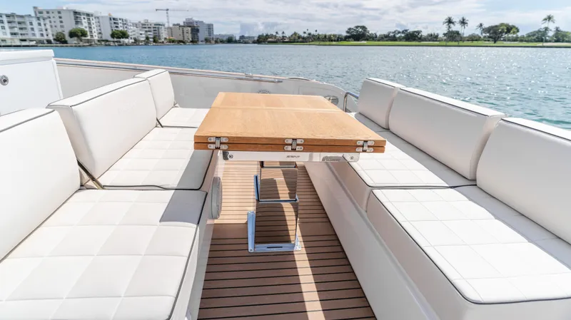 Slide: The Image of Luxury seating area on 2025 Pardo Yachts 38, featuring elegant white cushions and wooden table. - 15