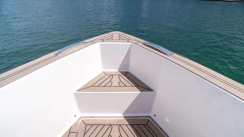 Slide: The Image of Pardo Yachts 38 (2025) bow with teak decking on calm water. - 27