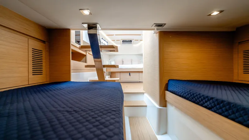 Slide: The Image of Luxurious interior of 2025 Pardo Yachts 38, featuring twin beds and modern wood finishes. - 35