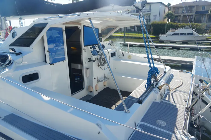 Slide: The Image of 1997 Gemini 105M sailboat cockpit with steering wheel, docked at marina. - 10
