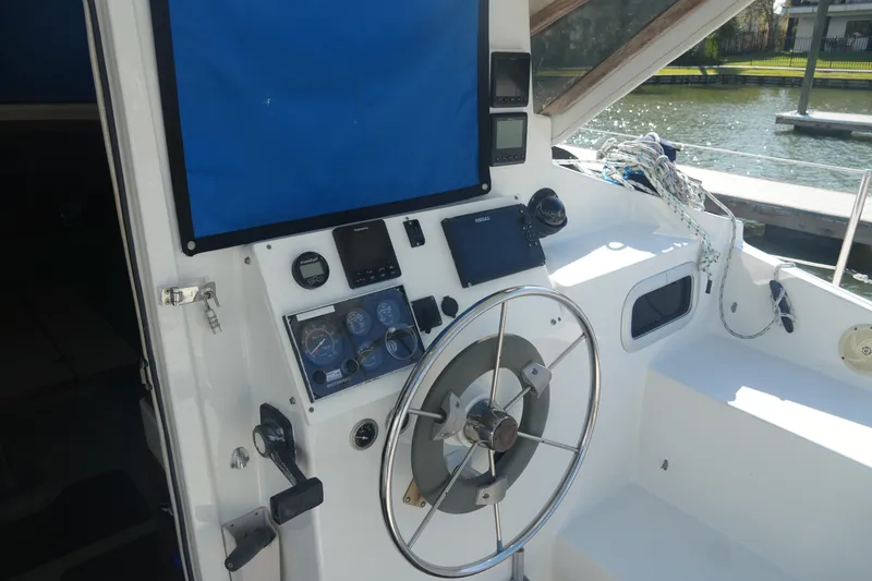 Slide: The Image of Cockpit of 1997 Gemini 105M sailboat with steering wheel and navigation instruments. - 11