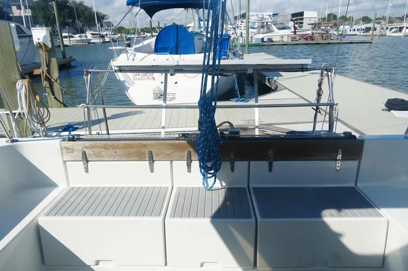 Slide: The Image of 1997 Gemini 105M sailboat docked at marina, featuring spacious cockpit and seating. - 13