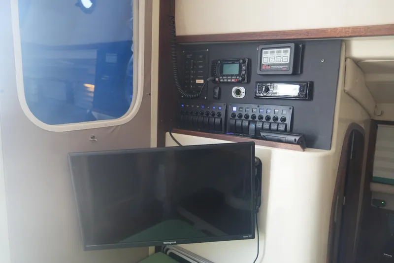 Slide: The Image of Interior of 1997 Gemini 105M boat with control panel and mounted TV. - 15