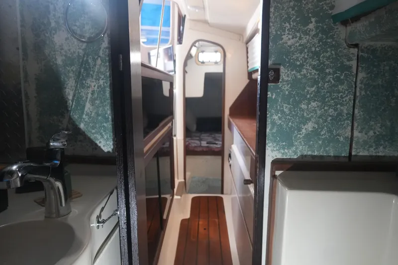 Slide: The Image of Interior of a 1997 Gemini 105M sailboat with wood flooring and compact design. - 18