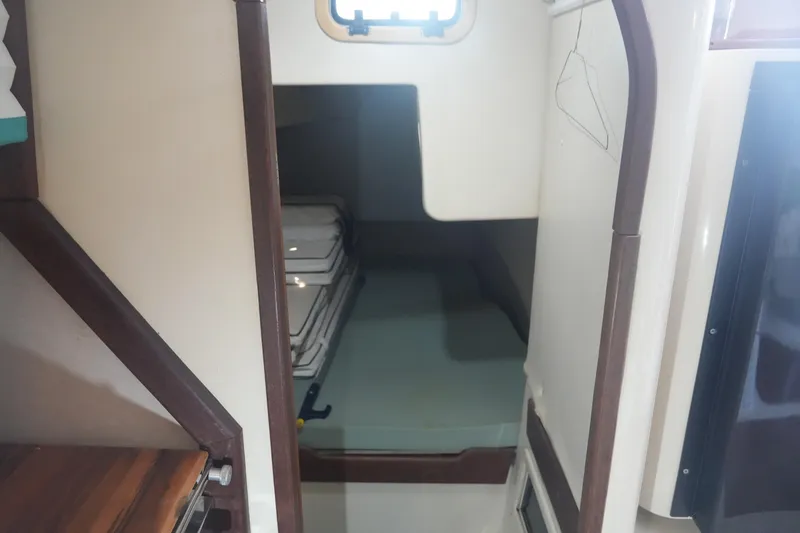 Slide: The Image of Interior cabin of a 1997 Gemini 105M sailboat, featuring a cozy sleeping area. - 21