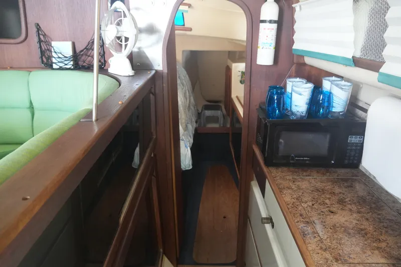 Slide: The Image of Interior of a 1997 Gemini 105M sailboat with kitchen and seating area. - 22