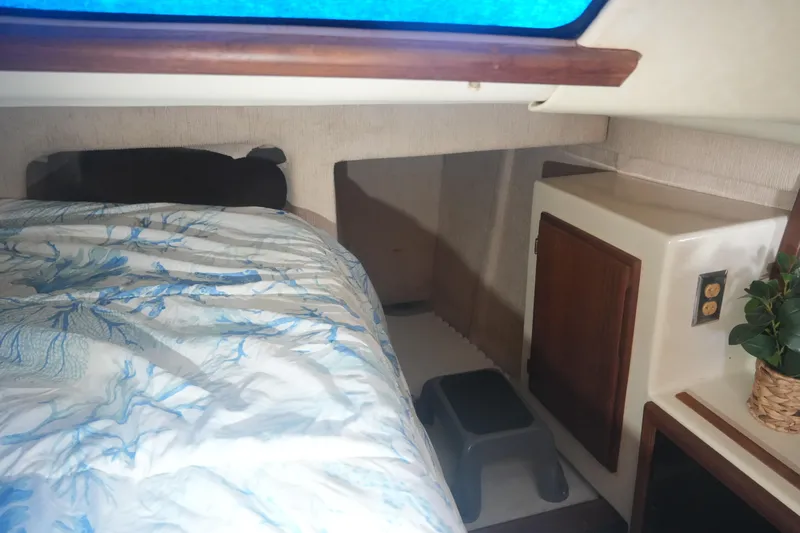 Slide: The Image of Cozy cabin interior of 1997 Gemini 105M sailboat with bed and storage. - 24