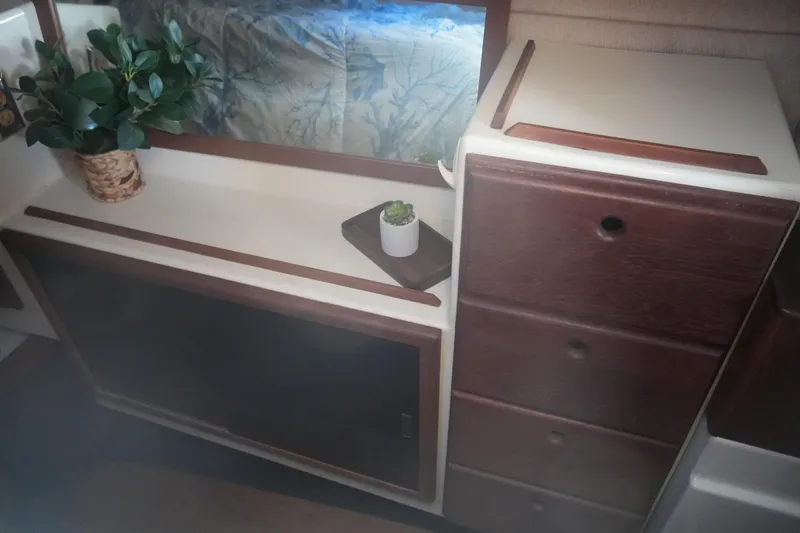 Slide: The Image of Interior of 1997 Gemini 105M with wooden cabinets and decorative plants. - 25