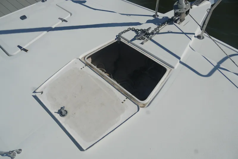 Slide: The Image of Open hatch on 1997 Gemini 105M boat deck with chain and shadows. - 7