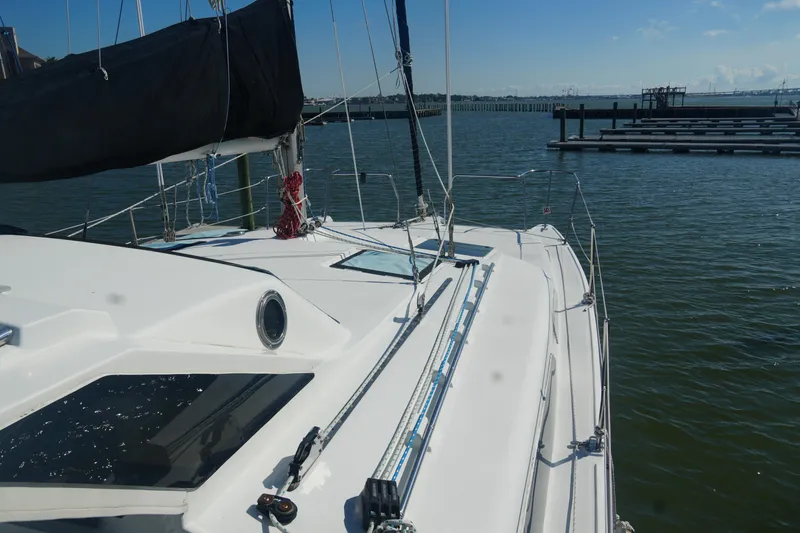 Slide: The Image of Sailing yacht Gemini 105M, 1997 model, docked in a serene marina setting. - 8