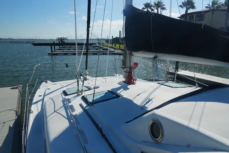 Slide: The Image of 1997 Gemini 105M sailboat docked by calm waters under clear skies. - 9