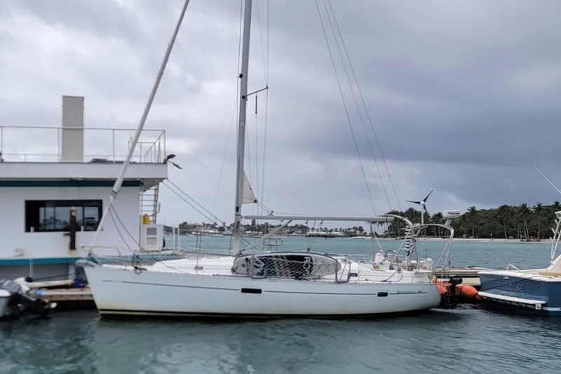 The Image of 2002 Beneteau Oceanis Clipper 361 sailboat docked at marina under cloudy skies. - 0