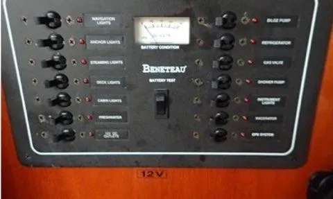 Slide: The Image of Control panel of a 2002 Beneteau Oceanis Clipper 361 sailboat, featuring various switches and battery condition meter. - 12