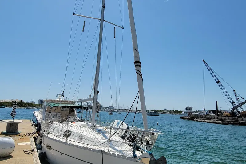 Slide: The Image of 2002 Beneteau Oceanis Clipper 361 sailboat docked at a sunny marina. - 2