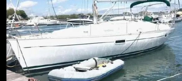 Slide: The Image of 2002 Beneteau Oceanis Clipper 361 sailboat docked with inflatable dinghy nearby. - 3