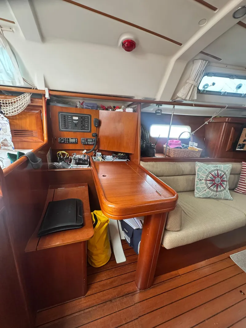 Slide: The Image of Interior of 2002 Beneteau Oceanis Clipper 361 sailboat with wooden furnishings and navigation station. - 31