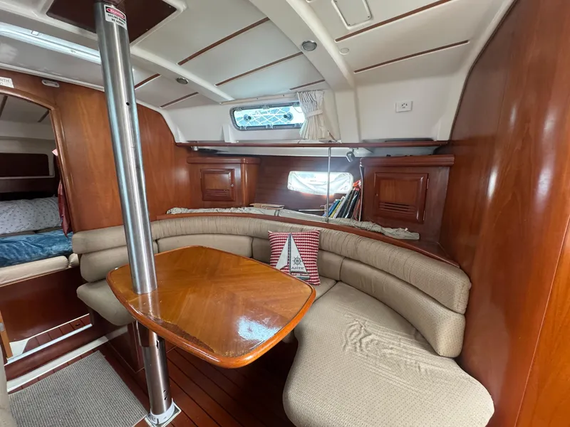 Slide: The Image of Cozy interior of 2002 Beneteau Oceanis Clipper 361 sailboat with wooden table and seating. - 34