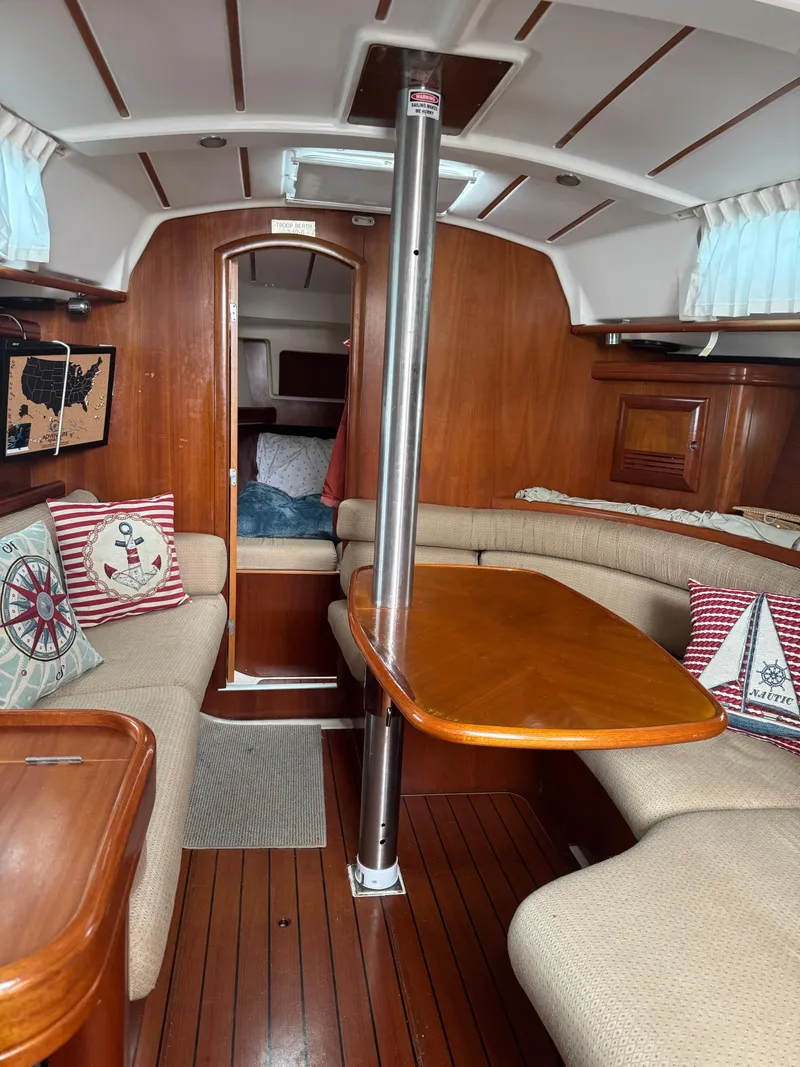 Slide: The Image of Interior of 2002 Beneteau Oceanis Clipper 361 sailboat with cozy seating and wooden finishes. - 35