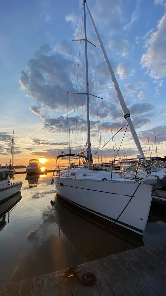 Slide: The Image of 2002 Beneteau Oceanis Clipper 361 sailboat docked at sunset with cloudy sky. - 36