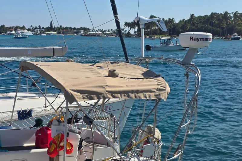 Slide: The Image of 2002 Beneteau Oceanis Clipper 361 sailboat with canopy, docked in sunny marina. - 37