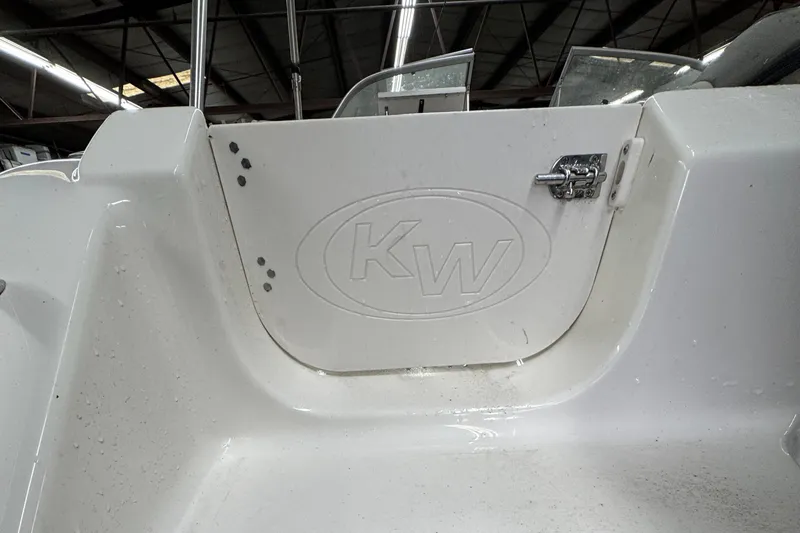 Slide: The Image of Key West 203DFS 2025 boat interior with KW logo and storage compartment. - 3