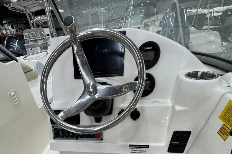 Slide: The Image of Steering console of 2025 Key West 203DFS boat with modern controls and gauges. - 6