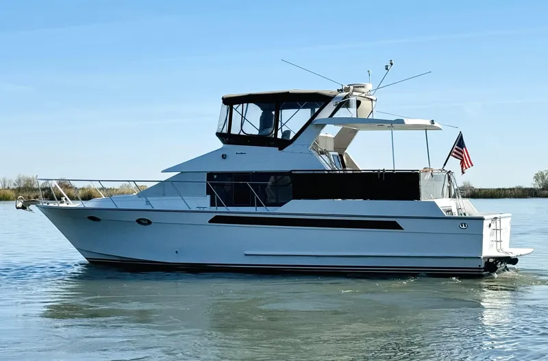 Slide: The Image of 1991 Ocean Alexander 440 Sundeck CPMY yacht on calm water, side view. - 14