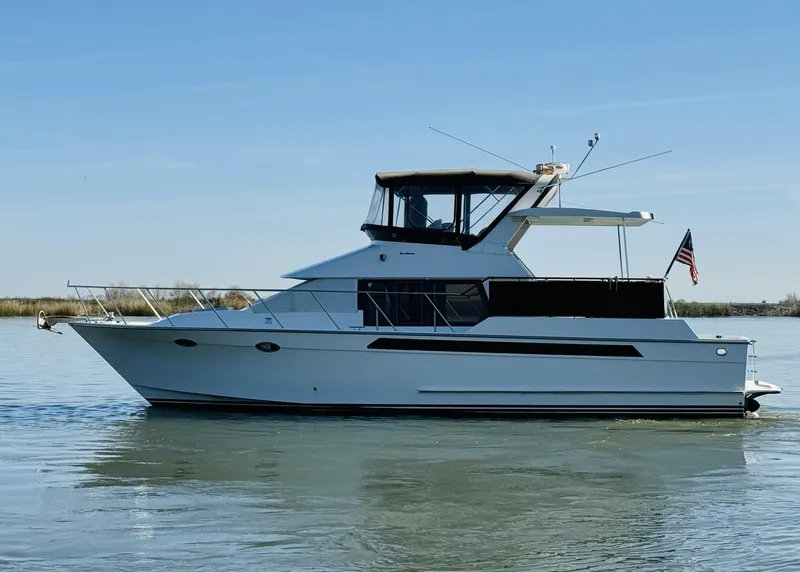 Slide: The Image of 1991 Ocean Alexander 440 Sundeck CPMY yacht on calm water, side view. - 15