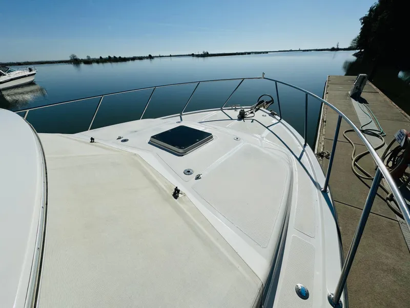 Slide: The Image of 1991 Ocean Alexander 440 Sundeck CPMY yacht docked by calm waters. - 17