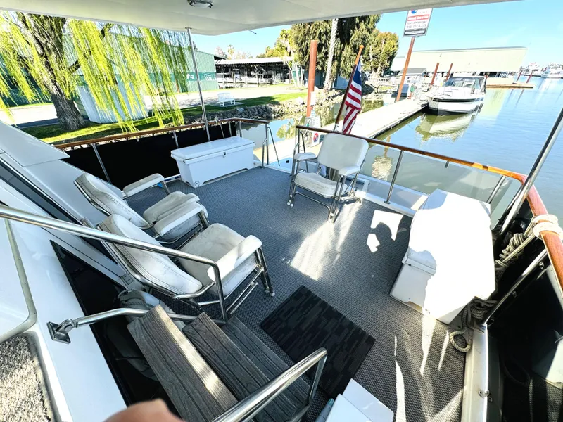Slide: The Image of Spacious deck of 1991 Ocean Alexander 440 Sundeck CPMY with seating and marina view. - 23