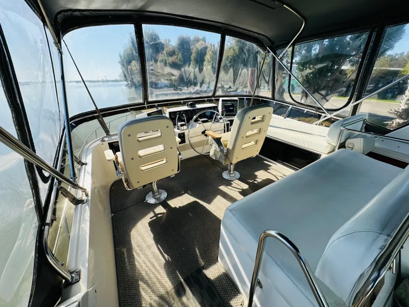 Slide: The Image of 1991 Ocean Alexander 440 Sundeck CPMY cockpit with helm, seating, and panoramic windows. - 26